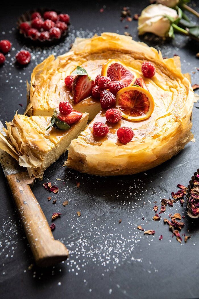 Whipped Lemon Ricotta Cheesecake with 1 slice cut