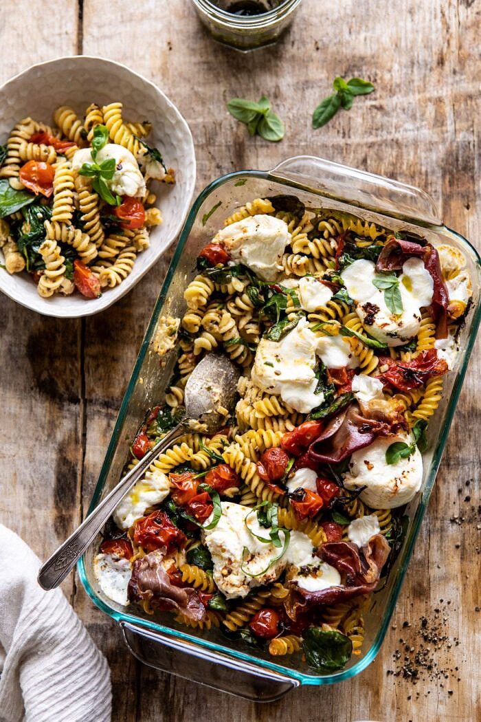 Caprese Pesto Pasta Bake | halfbakedharvest.com #caprese #pesto #pasta #easyrecipes overhead photo of Caprese Pesto Pasta Bake with bowl of food on surface