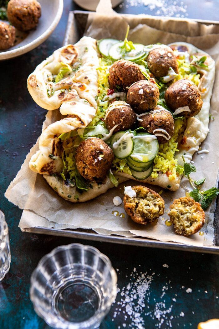 Falafel Naan Wraps with Golden Rice and Special Sauce | halfbakedharvest.com #falafel #wraps #middleeastern #vegan side angled photo of Falafel Naan Wraps with Golden Rice and Special Sauce