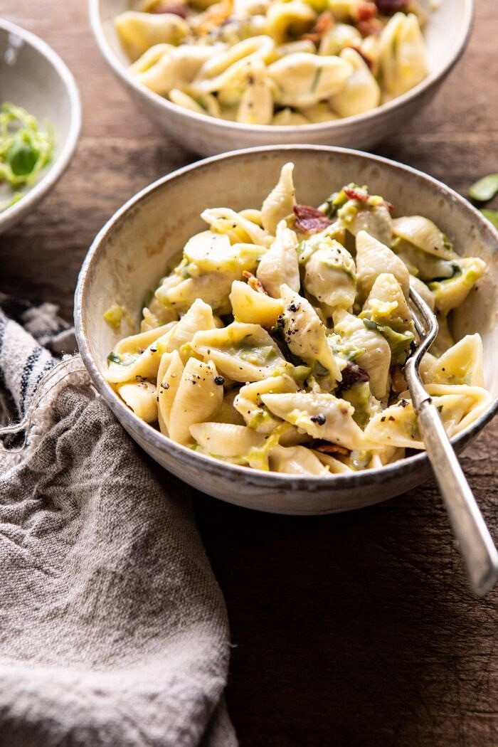 Instant Pot Irish Cheddar Bacon Mac and Cheese | halfbakedharvest.com #instantpot #macandcheese #easyrecipes #pasta #Irish side angled photo of Instant Pot Irish Cheddar Bacon Mac and Cheese with fork in bowl