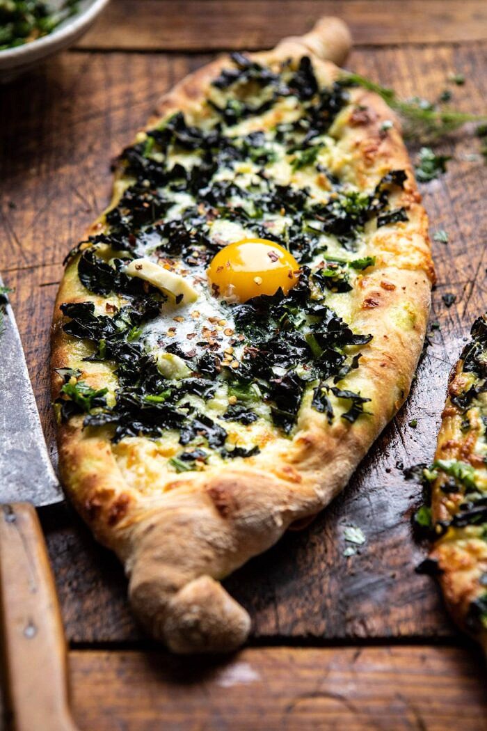 side angled photo of Khachapuri (Georgian Cheese Bread) with Kale and Herb Sauce