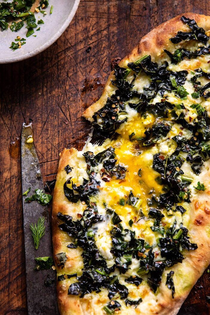 Khachapuri (Georgian Cheese Bread) with Kale and Herb Sauce | halfbakedharvest.com #pizza #easyrecipes #cheese #bread overhead close up photo Khachapuri (Georgian Cheese Bread) with Kale and Herb Sauce