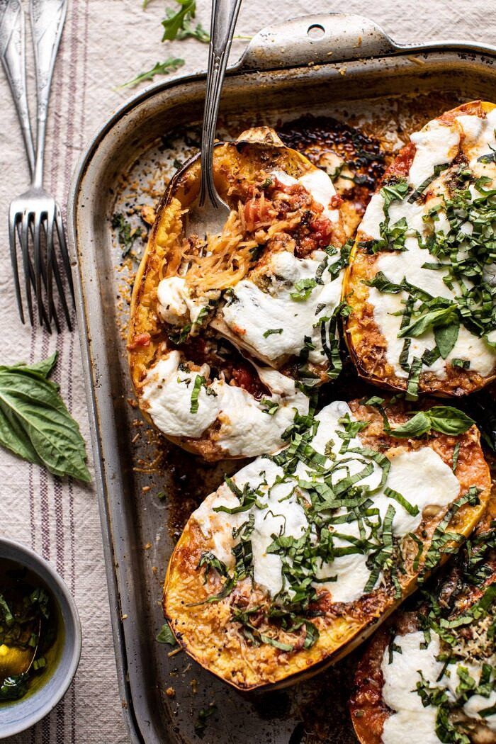 Spicy Tomato Parmesan Stuffed Spaghetti Squash | halfbakedharvest.com #spaghettisquash #healthyrecipes #easyrecipes #dinner Spicy Tomato Parmesan Stuffed Spaghetti Squash with fork in squash pulling up noodles