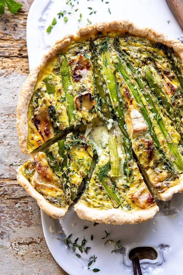 overhead photo of Asparagus and Brie Quiche with 2 slices cut