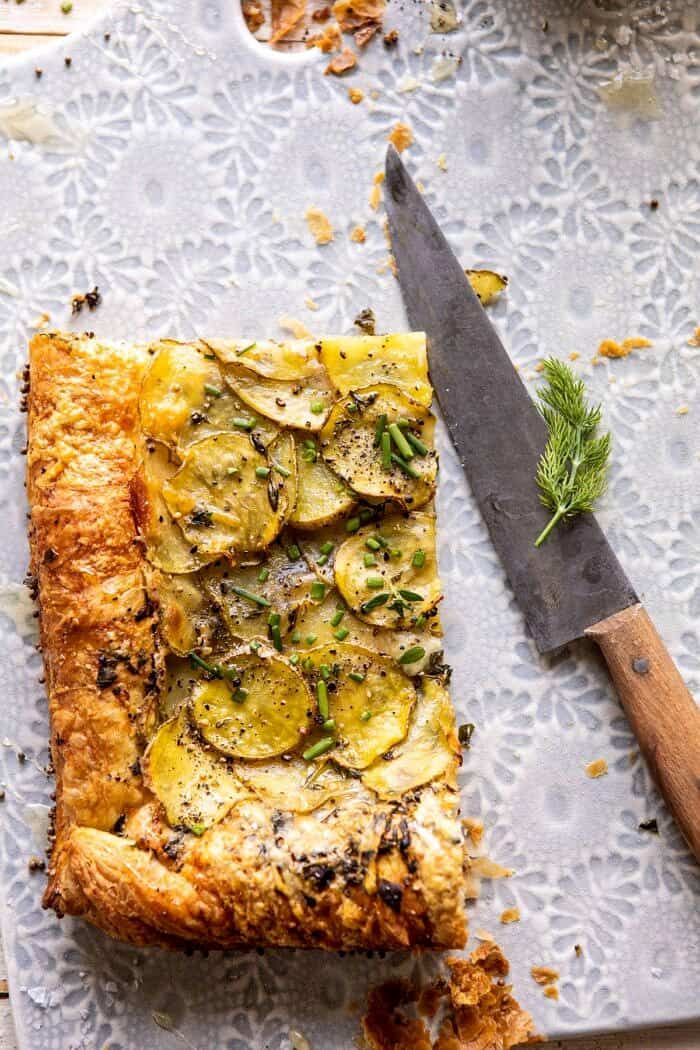Cheesy Potato Chive Galette | halfbakedharvest.com #potato #cheese #easyrecipes #appetizer #Easter #spring overhead photo of Cheesy Potato Chive Galette slice