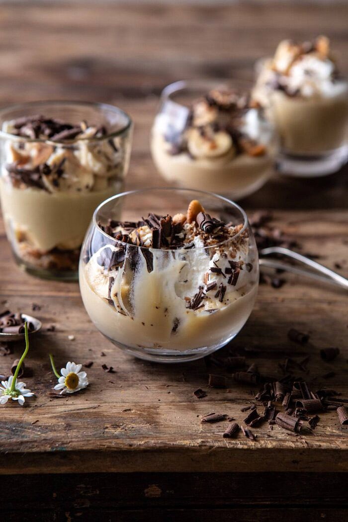 Coconut Banana Cream Pie Parfaits | halfbakedharvest.com #coconutpie #banana #dessertrecipes #easter Coconut Banana Cream Pie Parfaits with bite taken out of parfaits