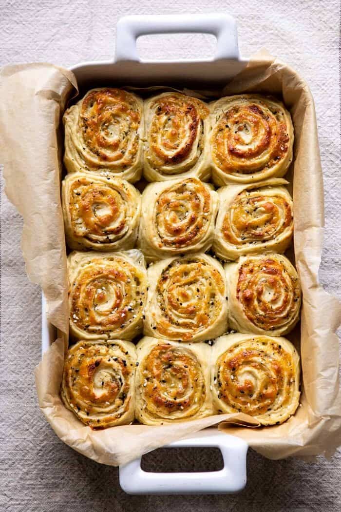 Herby Everything Cheddar Swirl Buns in baking dish