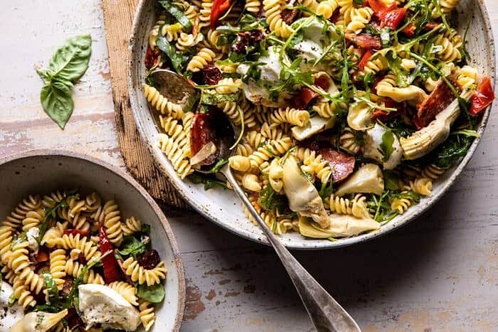 Antipasto Pasta Salad with Herby Parmesan Vinaigrette | halfbakedharvet.com #pasta #easyrecipes #pastasalad #mothersday horizontal photo of Antipasto Pasta Salad with Herby Parmesan Vinaigrette