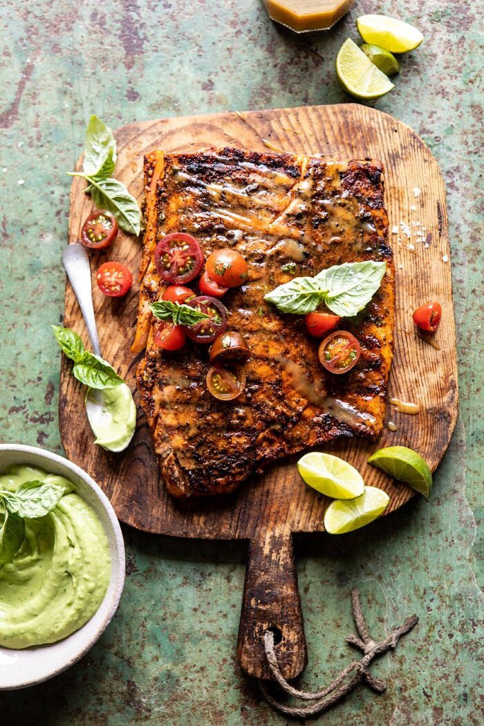 Honey Mustard Grilled Salmon with Avocado Basil Sauce | halfbakedharvest.com #grilling #salmon #summer #healthyrecipes overhead photo of Honey Mustard Grilled Salmon with Avocado Basil Sauce on small cutting board