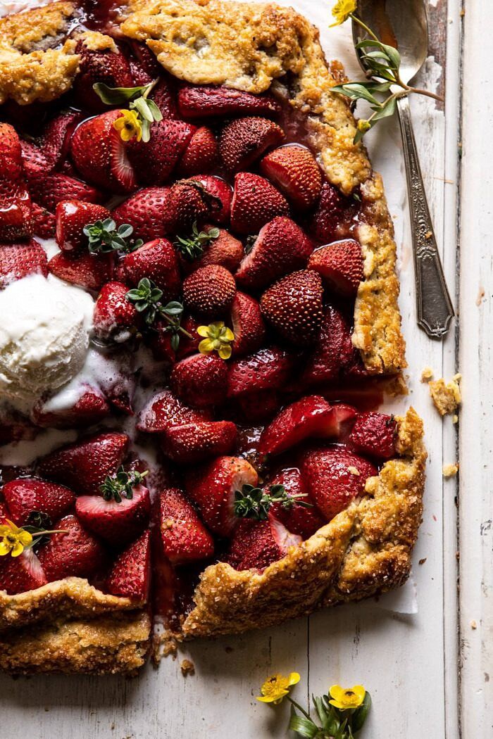 Jammy Strawberry Galette | halfbakedharvest.com #strawberries #tart #summer #fruit #springrecipes overhead close up photo of Jammy Strawberry Galette with ice cream on top