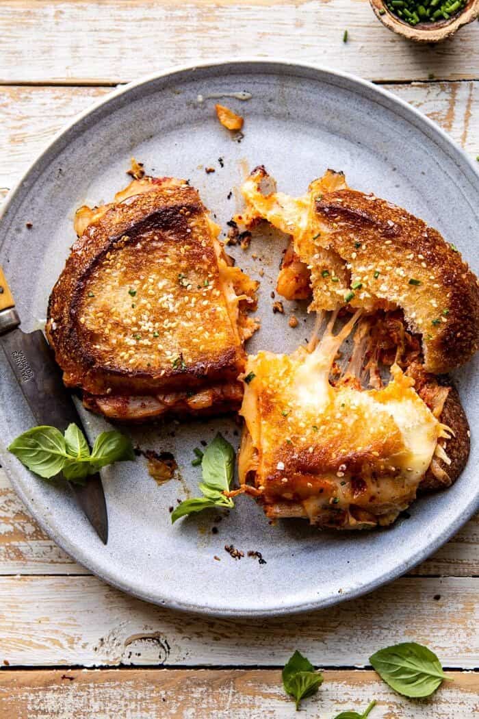 Kimchi Grilled Cheese | halfbakedharvest.com #grilledcheese #easyrecipes #korean overhead photo of Kimchi Grilled Cheese with sandwich broken in half to expose the cheese