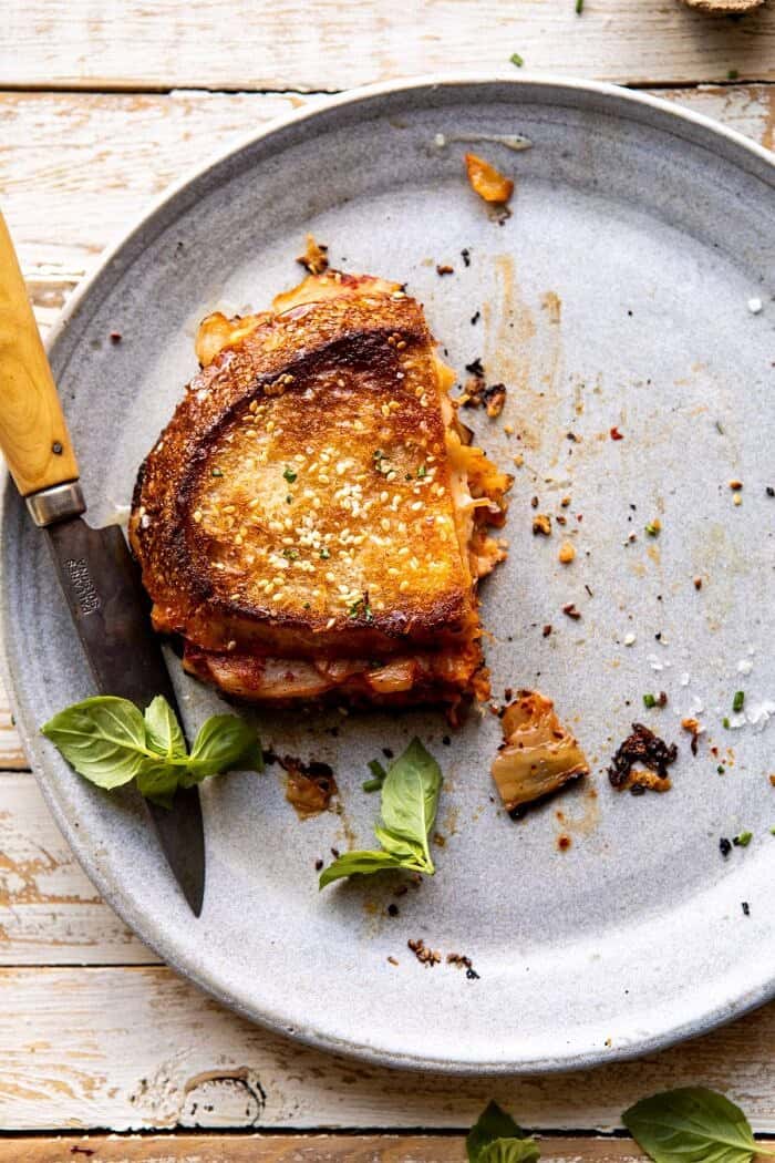 Kimchi Grilled Cheese | halfbakedharvest.com #grilledcheese #easyrecipes #korean overhead photo of Kimchi Grilled Cheese with half of the sandwich missing