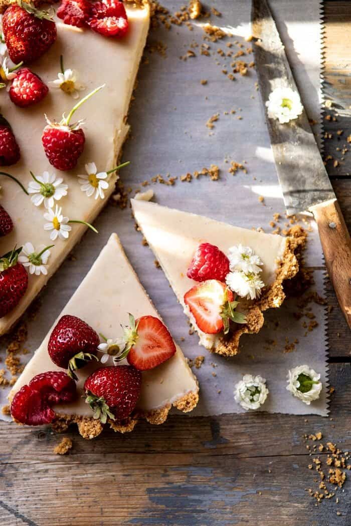overhead close up photo of No Fuss Lemon Tart with 2 slices cut and 1 slice missing from tart