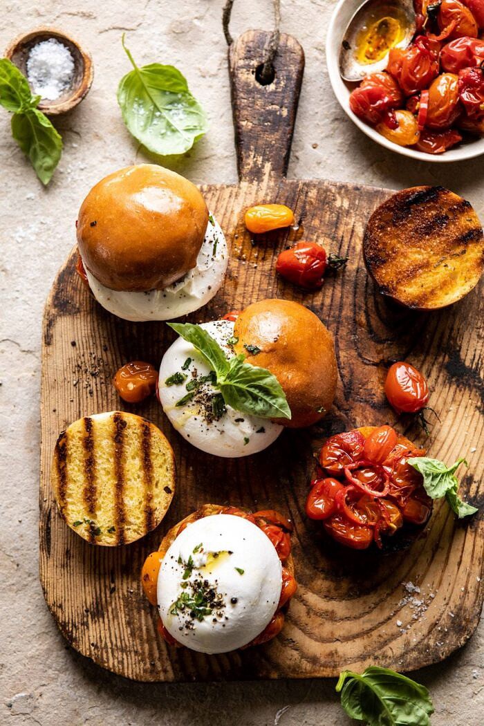 Roasted Caprese Burrata Sliders | halfbakedharvest.com #summerrecipes #appetizer #mothersday #burrata overhead close up photo of Roasted Caprese Burrata Sliders