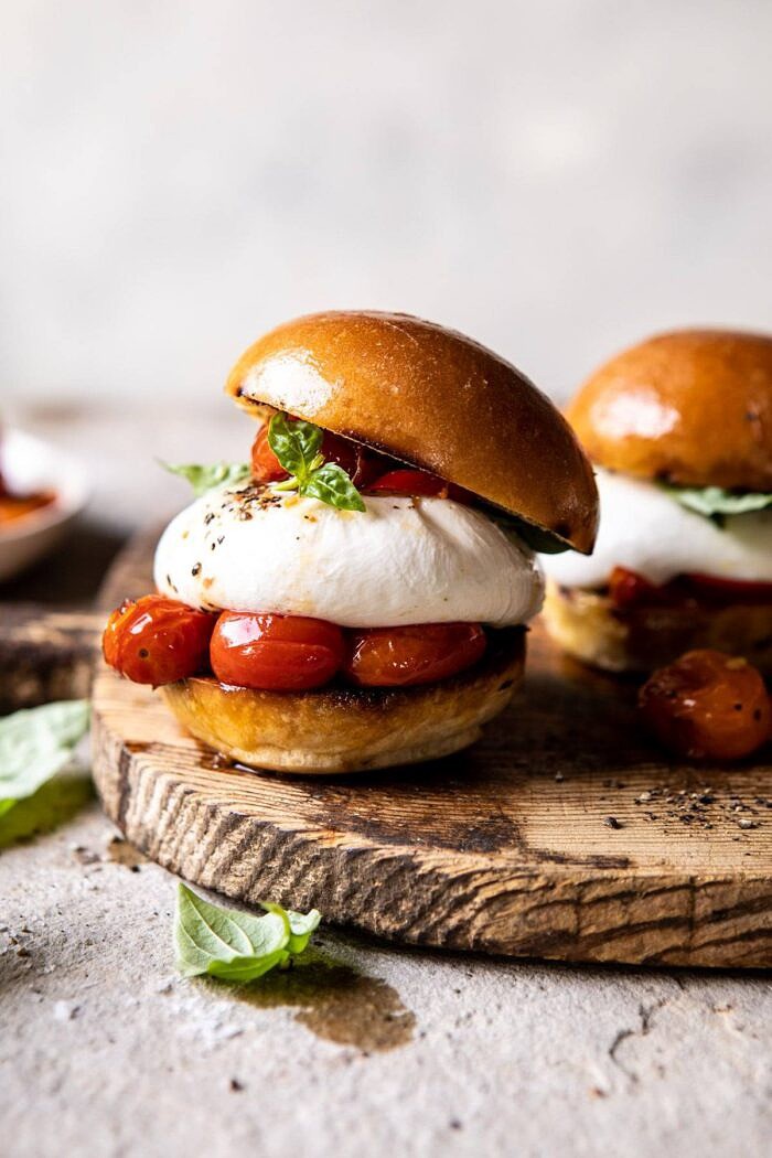 Roasted Caprese Burrata Sliders | halfbakedharvest.com #summerrecipes #appetizer #mothersday #burrata front on photo of Roasted Caprese Burrata Sliders on cutting board