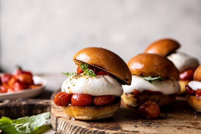 Roasted Caprese Burrata Sliders | halfbakedharvest.com #summerrecipes #appetizer #mothersday #burrata horizontal front on photo of Roasted Caprese Burrata Sliders