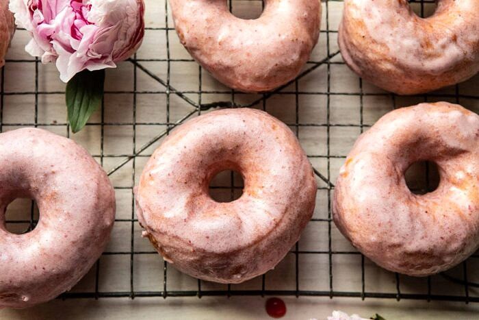 Strawberry Glazed Chai Doughnuts | halfbakedharvest.com #doughnuts #spring #strawberries horizontal photo of Strawberry Glazed Chai Doughnuts