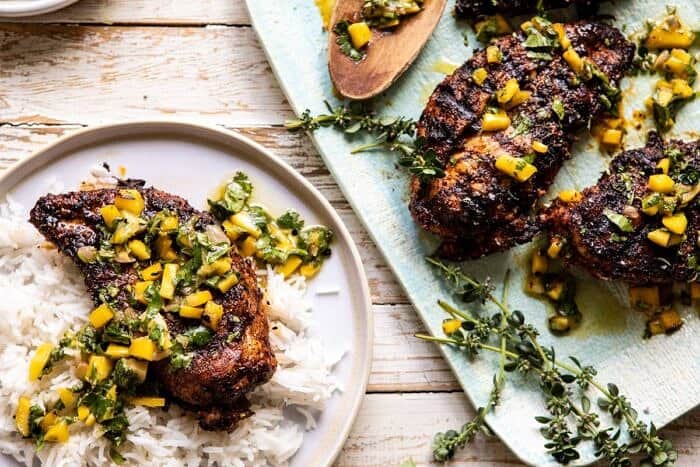 Tropical Jerk Grilled Chicken with Charred Mango Salsa Verde | halfbakedharvest.com #chicken #grilled #easyrecipe #healthy horizontal photo of Tropical Jerk Grilled Chicken with Charred Mango Salsa Verde