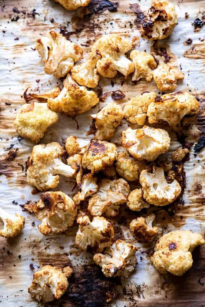 Better Than Takeout Kung Pao Cauliflower | halfbakedharvest.com #vegan #healthyrecipes #easyrecipes #vegetables roasted cauliflower on baking sheet before tossing with sauce