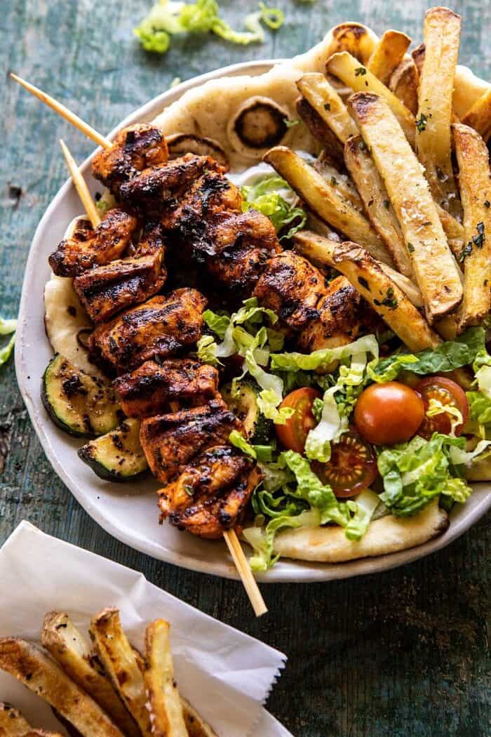 overhead close up photo of Chicken Souvlaki Bowls with Garlic Fries