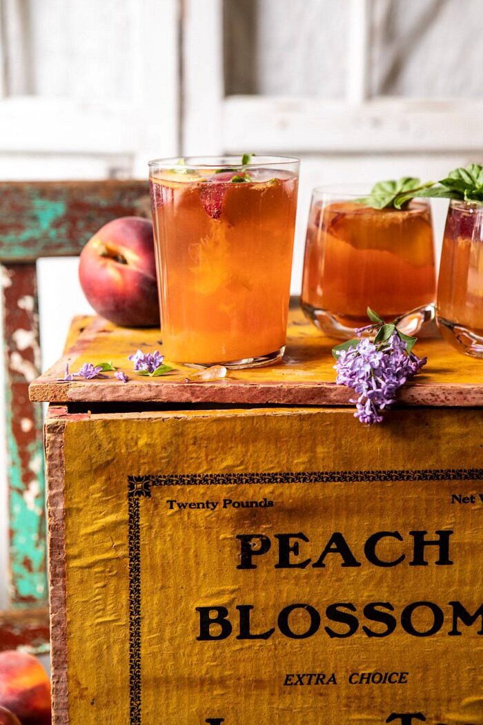 Balsamic Peach Spritz | halfbakedharvest.com #peach #peaches #wine #cocktail #drinks side angled photo of Balsamic Peach Spritz on peach box