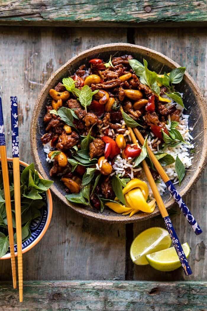 Better Than Takeout Sweet Thai Basil Chicken | halfbakedharvest.com #easyrecipes #20minutes #thaichicken #ricebowl #healthy overhead photo of Better Than Takeout Sweet Thai Basil Chicken with chopsticks resting in bowl
