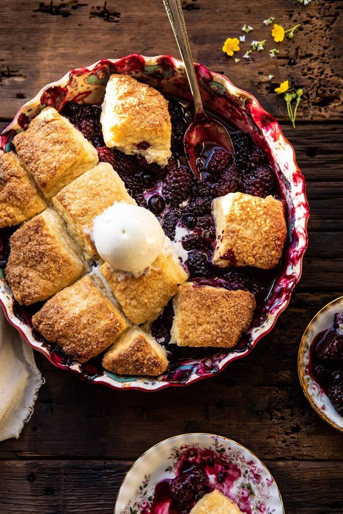 Blackberry Lavender Cobbler | halfbakedharvest.com #cobbler #blackerry #dessert overhead photo of Blackberry Lavender Cobbler with servings of cobbler removed from dish and spoon resting in cobbler