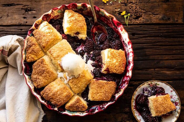 Blackberry Lavender Cobbler | halfbakedharvest.com #cobbler #blackerry #dessert horizontal photo of Blackberry Lavender Cobbler with spoon in baking dish