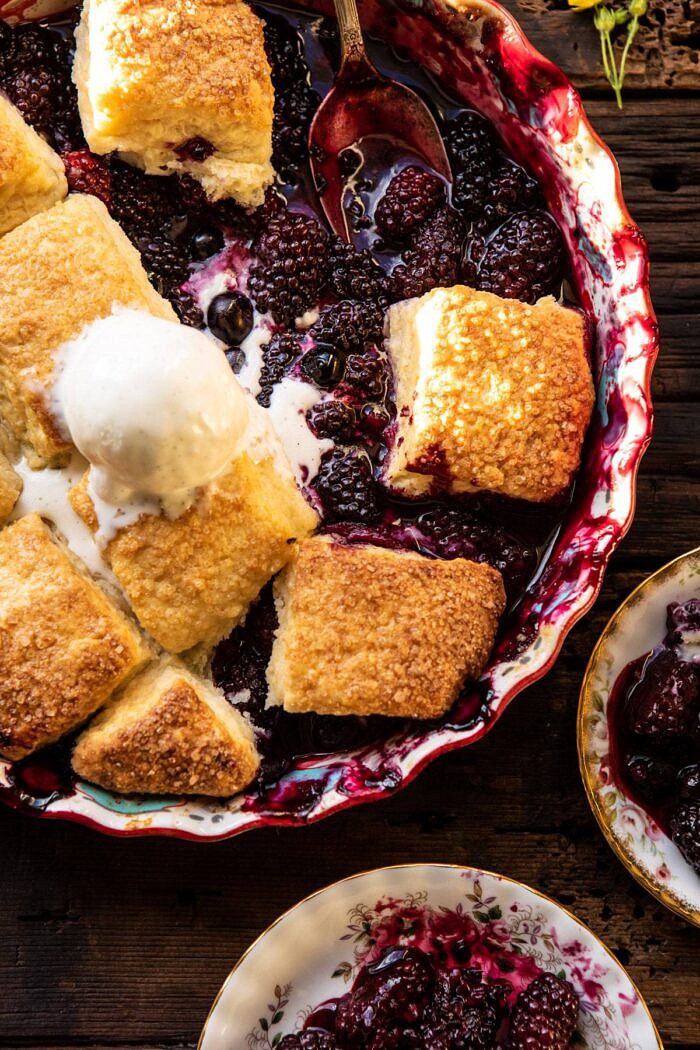 Blackberry Lavender Cobbler | halfbakedharvest.com #cobbler #blackerry #dessert overhead close up photo of Blackberry Lavender Cobbler with ice cream in baking dish
