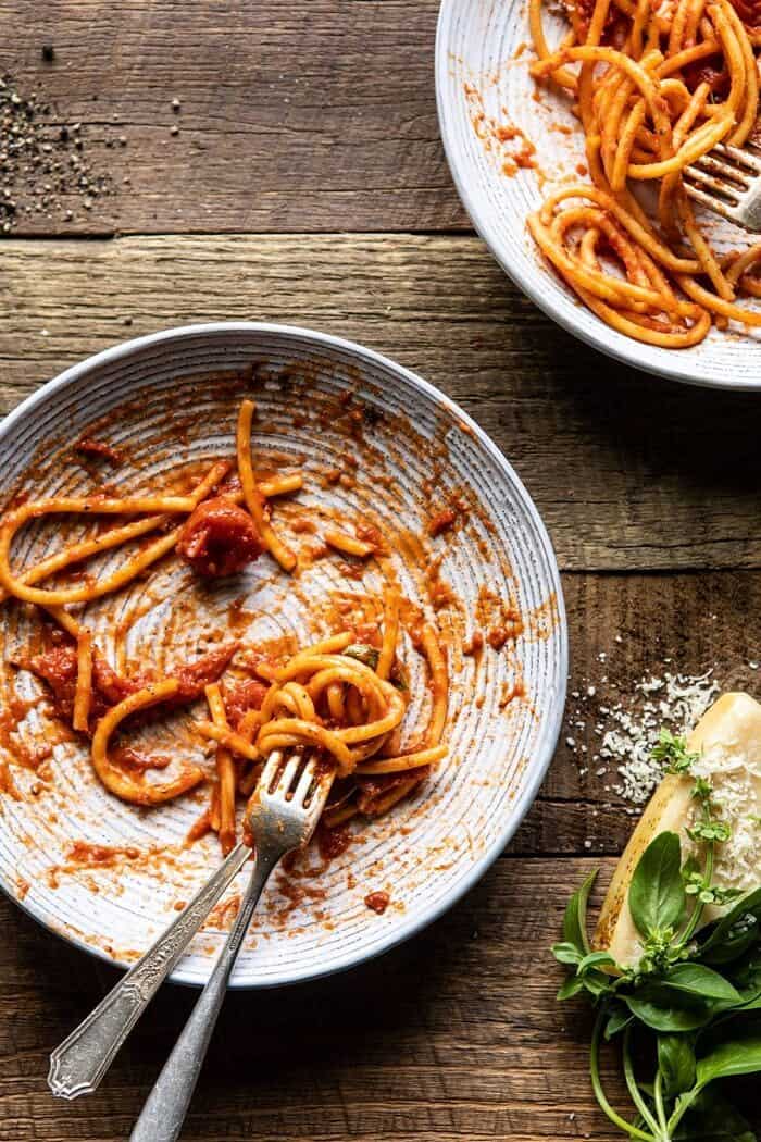 Bucatini Amatriciana | halfbakedharvest.com #pasta #easyrecipes #italian overhead photo of empty bowl of Bucatini Amatriciana with fork in pasta