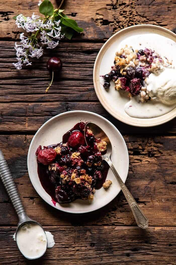 Buttery Cherry Berry Skillet Crisp | halfbakedharvest.com #berries #summerrecipes #easyrecipes #cherries Buttery Cherry Berry Skillet Crisp on 2 serving plates with ice cream