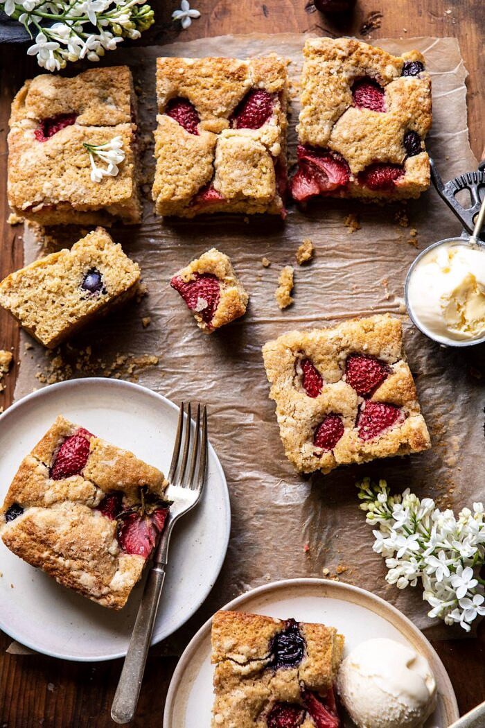 Cherry Strawberry Streusel Cake | halfbakedharvest.com #easyrecipes #cake #sheetcake #summerdessert overhead photo of Cherry Strawberry Streusel Cake pieces on plates