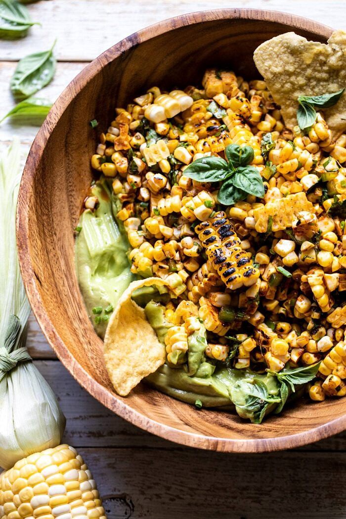 Grilled Street Corn Salad with Avocado Mayo | halfbakedharvest.com #corn #salad #easyrecipes #summer overhead close up photo of Grilled Street Corn Salad with Avocado Mayo with chip in bowl