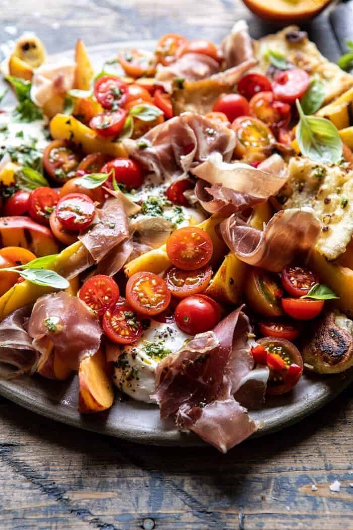 Peach Caprese Salad with Toasted Garlic Naan | halfbakedharvest.com #salad #peaches #burrata side angled photo of Peach Caprese Salad with Toasted Garlic Naan