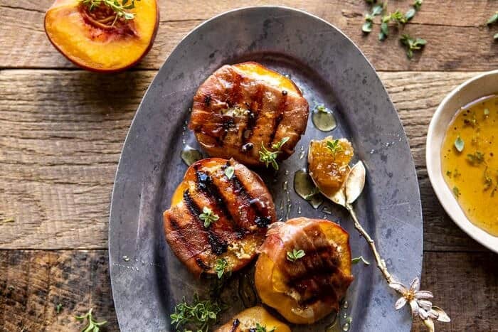 Prosciutto Goat Cheese Stuffed Peaches with Thyme Honey | halfbakedharvest.com #peaches #appetizer #goatcheese overhead horizontal photo of Prosciutto Goat Cheese Stuffed Peaches with Thyme Honey