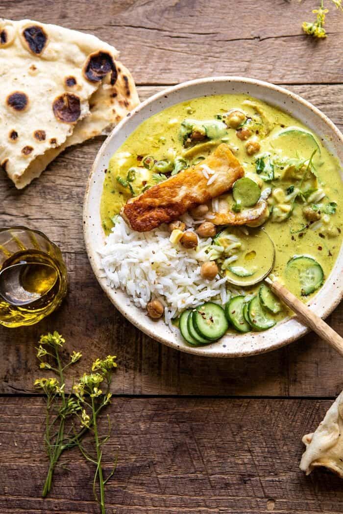 Summer Coconut Chickpea Curry with Rice and Fried Halloumi | halfbakedharvest.com #coconut #vegan #curry #easyrecipes #summer overhead photo of Summer Coconut Chickpea Curry with Rice and Fried Halloumi with spoon in bowl
