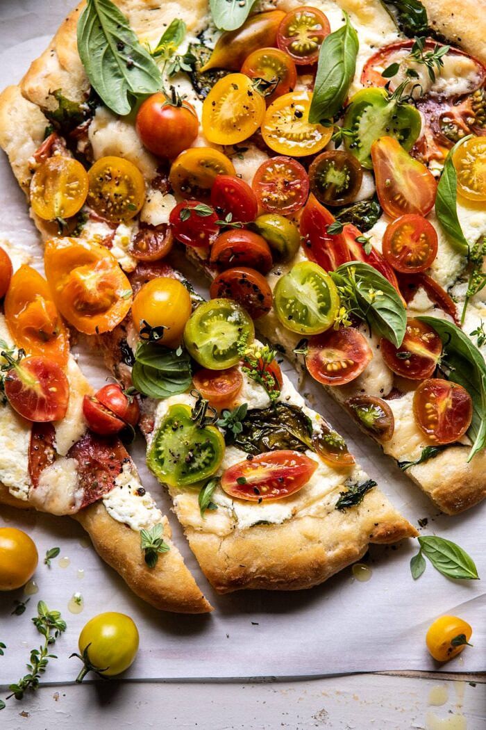 Herbed Butter Heirloom Tomato Pizza | halfbakedharvest.com #pizza #easyrecipe #tomatoes overhead close up photo of Herbed Butter Heirloom Tomato Pizza