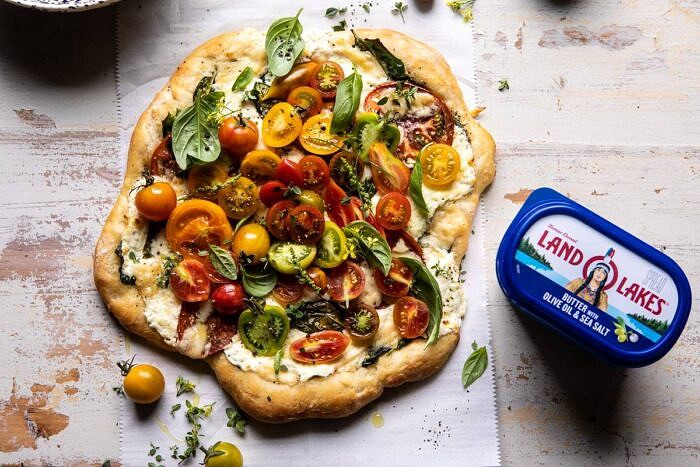 Herbed Butter Heirloom Tomato Pizza | halfbakedharvest.com #pizza #easyrecipe #tomatoes horizontal photo of Herbed Butter Heirloom Tomato Pizza