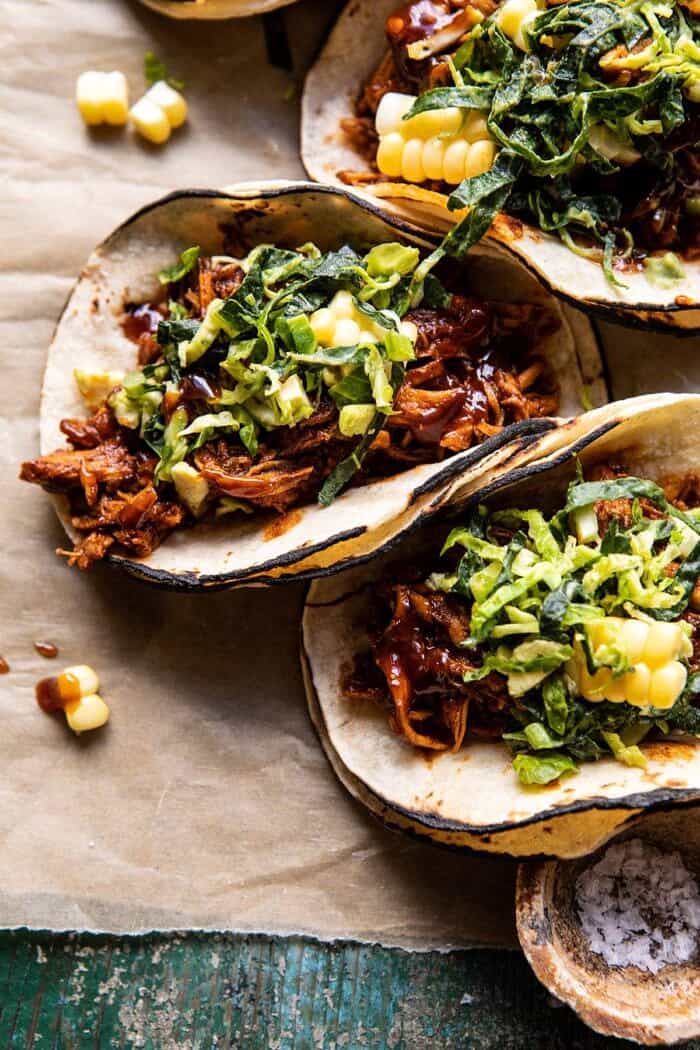 Instant Pot BBQ Beer Pulled Chicken Tacos with Ranch Corn Slaw | halfbakedharvest.com #instantpot #slowcooker #easyrecipes #tacos side angled, close up photo of Instant Pot BBQ Beer Pulled Chicken Tacos with Ranch Corn Slaw