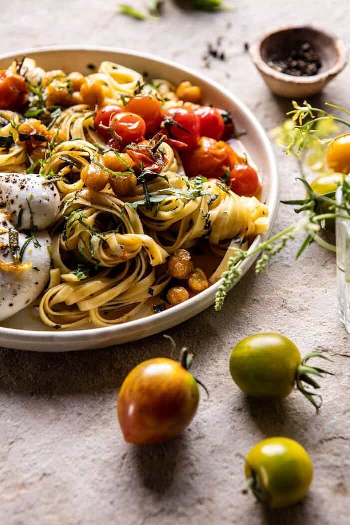 Jammy Cherry Tomato Pasta with Crisp Lemon Rosemary Chickpeas | halfbakedharvest.com #pasta #tomatoes #burrata side angled close up photo of Jammy Cherry Tomato Pasta with Crisp Lemon Rosemary Chickpeas