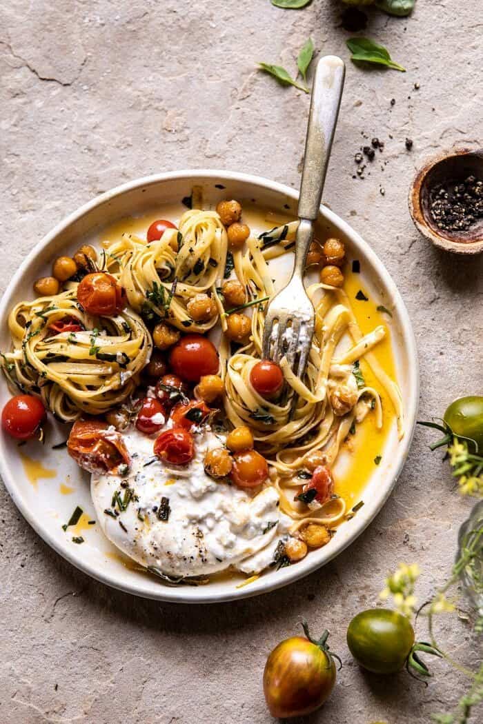 Jammy Cherry Tomato Pasta with Crisp Lemon Rosemary Chickpeas | halfbakedharvest.com #pasta #tomatoes #burrata overhead photo Jammy Cherry Tomato Pasta with Crisp Lemon Rosemary Chickpeas with fork on plate twirling the pasta