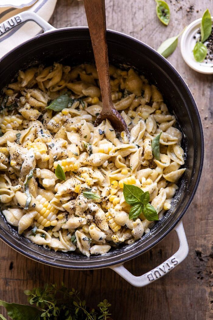 One Pot Lemon Basil, Corn, and Ricotta Pasta | halfbakedharvest.com #onepot #easyrecipes #pasta #summer overhead close up photo of One Pot Lemon Basil, Corn, and Ricotta Pasta with spoon in pot
