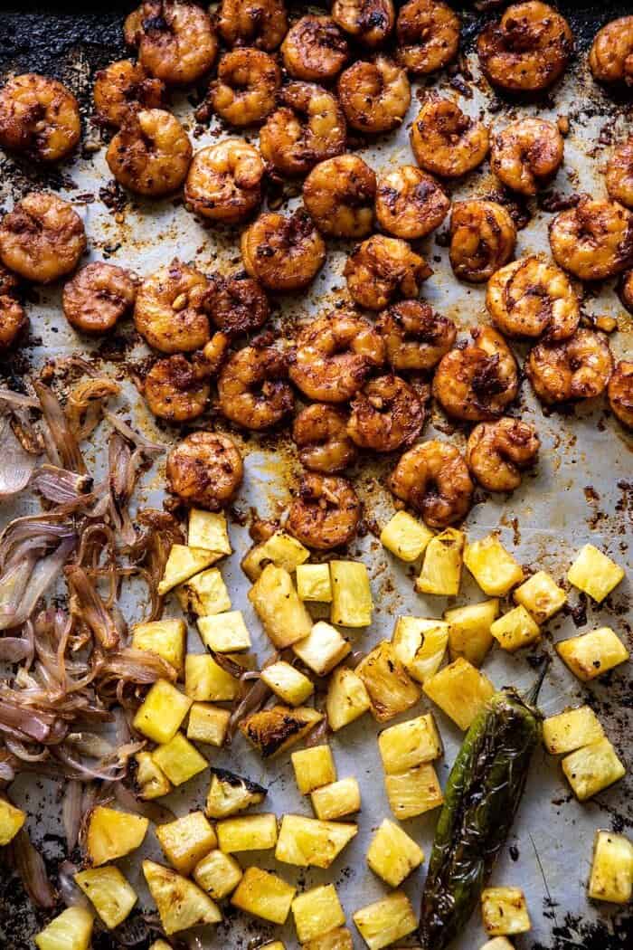 Sheet Pan Hawaiian Pineapple Shrimp Tacos | halfbakedharvest.com #sheetpan #tacos #easyrecipes #seafood shrimp and pineapple on sheet pan after cooking