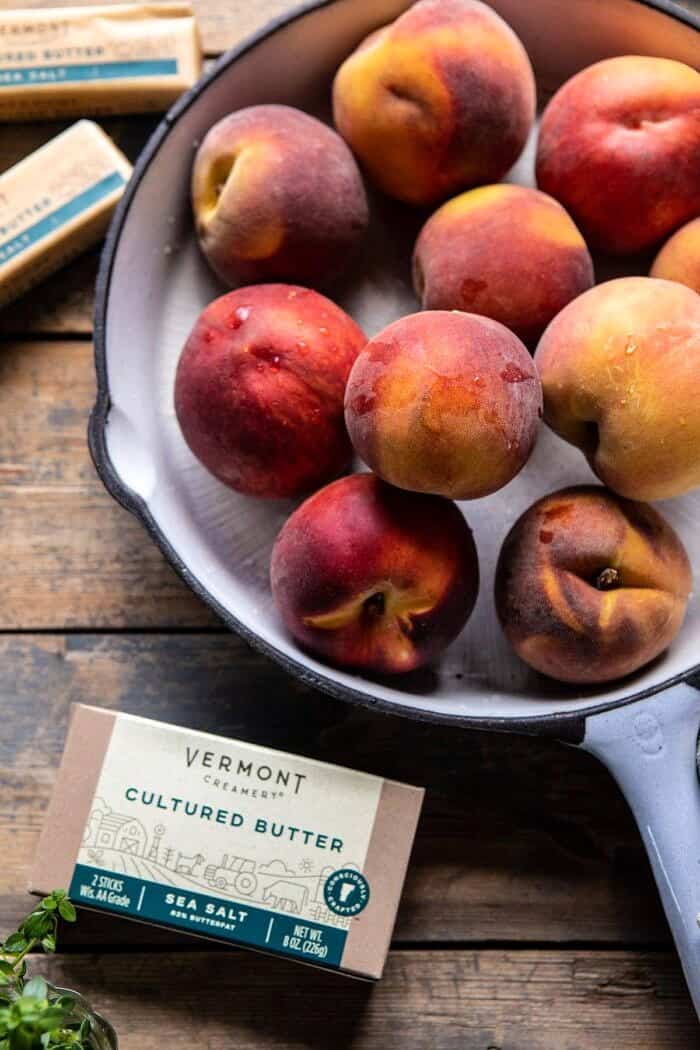 Skillet Brown Sugar Peach Cobbler | halfbakedharvest.com #peach #summer #easyrecipes #cobbler overhead process photo of peaches with butter in photo