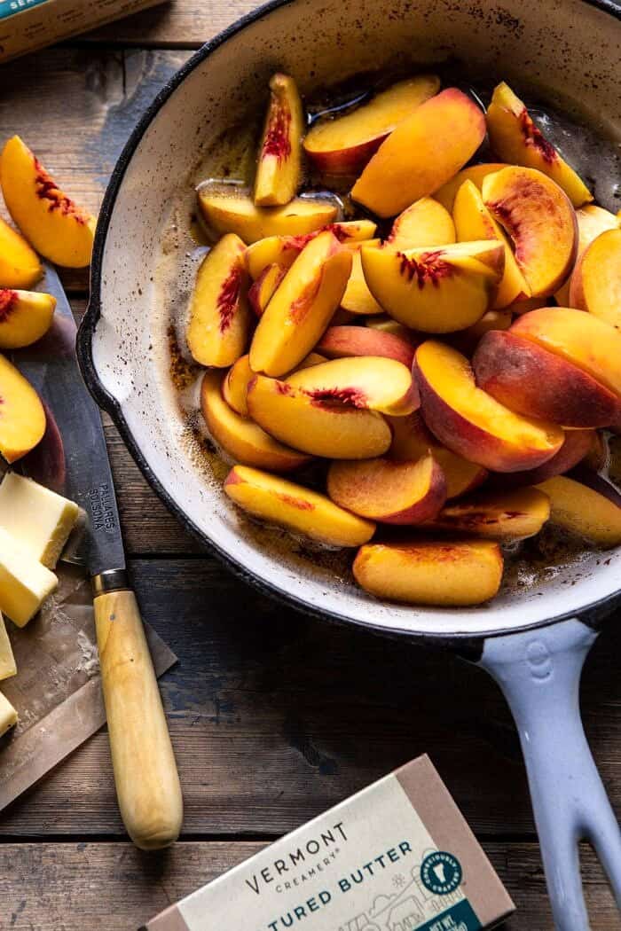 Skillet Brown Sugar Peach Cobbler | halfbakedharvest.com #peach #summer #easyrecipes #cobbler overhead photo of sliced peaches in skillet with browned butter before baking