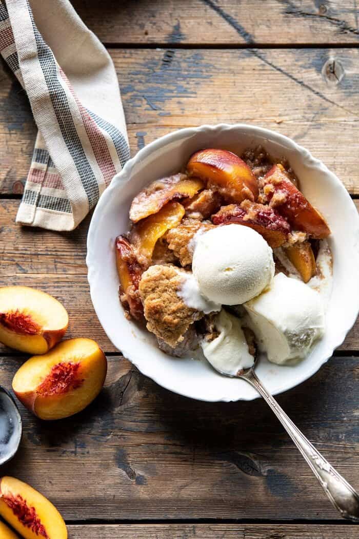 Skillet Brown Sugar Peach Cobbler | halfbakedharvest.com #peach #summer #easyrecipes #cobbler overhead photo of Skillet Brown Sugar Peach Cobbler in single serving dish with spoon in dish