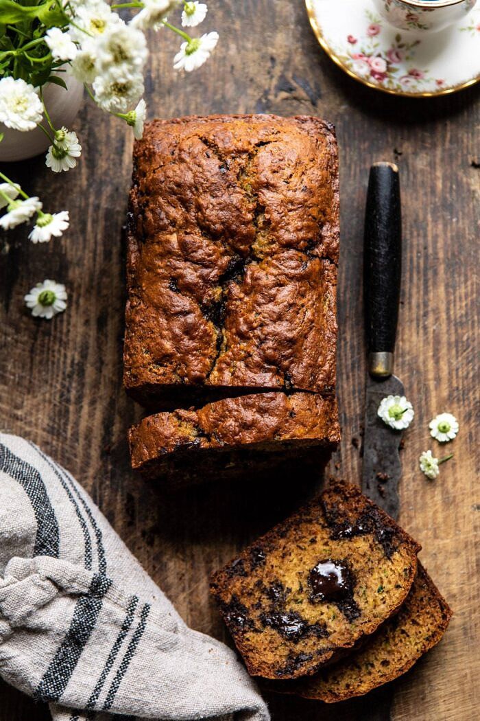 overhead photo of Sneaky Zucchini Chocolate Chunk Coconut Bread with 2 slices cut to show the chocolate inside