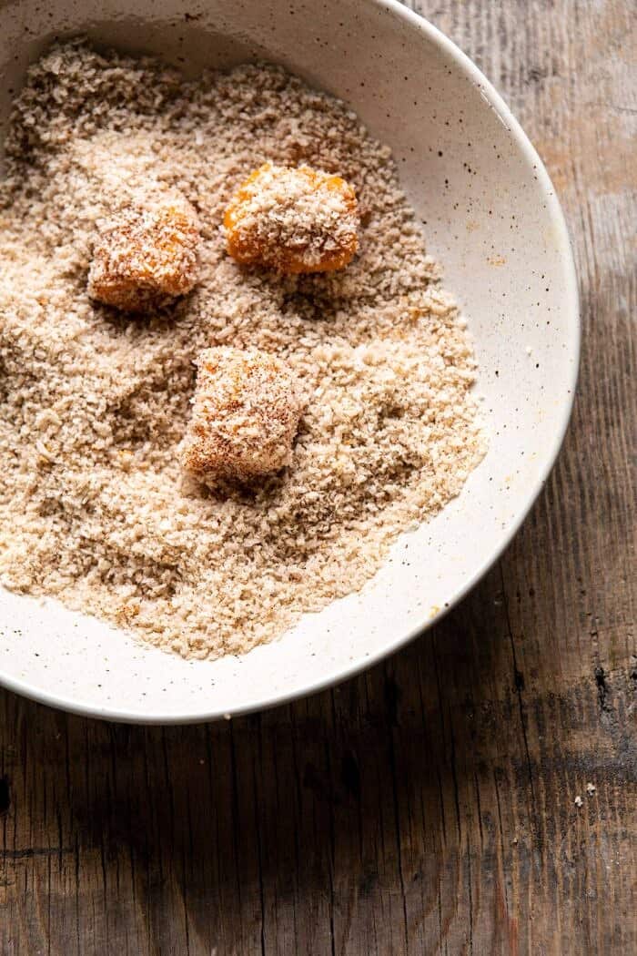 overhead photo of sweet potato tots being rolled in bread crumbs 