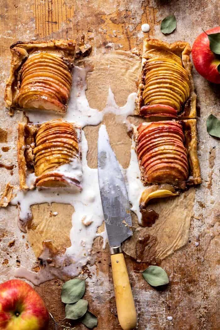 Chai Spiced Apple Ricotta Galette | halfbakedhavest.com #apple #pastry #fallrecipes #autumn overhead photo of Chai Spiced Apple Ricotta Galette with slices of the tart removed and melted ice cream