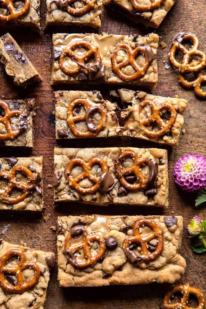 Chocolate Peanut Butter Pretzel Blondies | halfbakedharvest.com #peanutbutter #chocolate #pretzels #fall #autumn #dessert overhead close up photo of Chocolate Peanut Butter Pretzel Blondies with 1 blondie broken in half